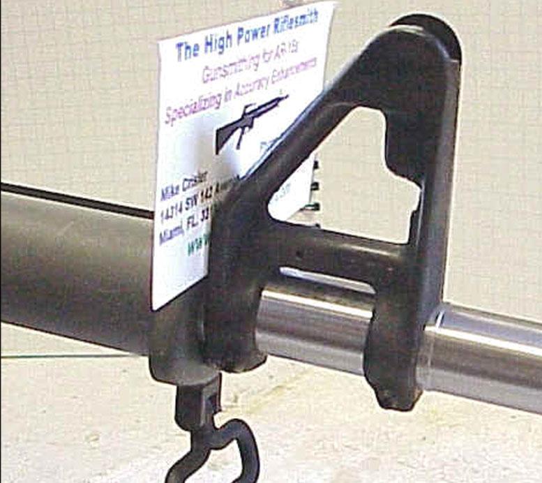 close up of rifle with sign of The High Power Rifle